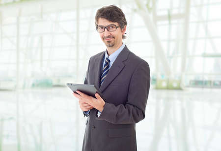 happy businessman with a tablet pc, at the officeの写真素材