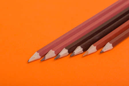 Wooden colorful pencils, on a orange backgroundの写真素材