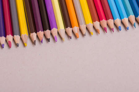 Wooden colorful pencils, on a grey paperの写真素材