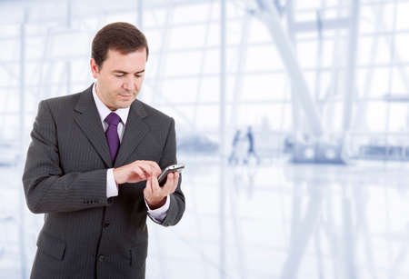 young business man looking worried to his phone, at the officeの写真素材