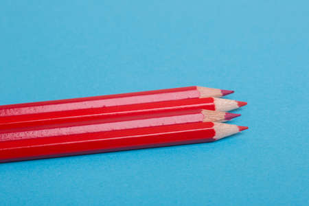 Wooden red pencils, on a blue backgroundの写真素材