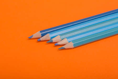 Wooden colorful pencils, on a orange backgroundの写真素材
