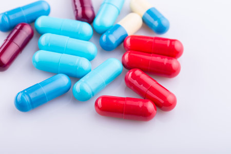 Tablets pills capsule heap mix therapy drugs, over a white backgroundの写真素材