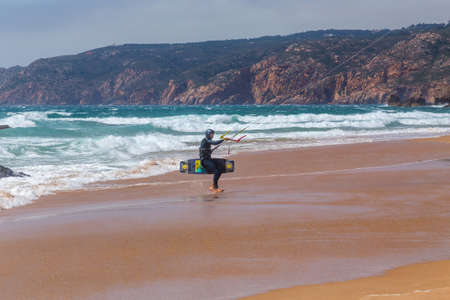 Guincho beach sea with surfers doing kitesurf and with the blue sky in the background, Cascais, Portugalのeditorial素材