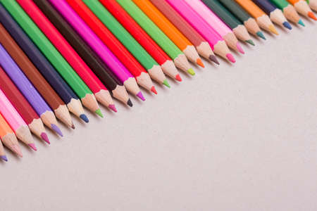 Wooden colorful pencils, on a grey paperの写真素材