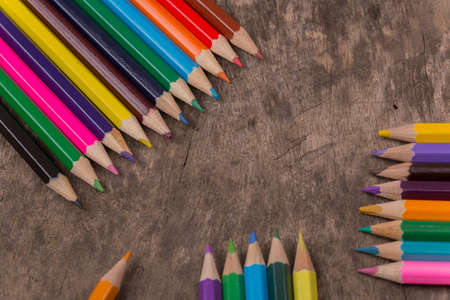 Wooden colorful pencils on a old wooden backgroundの写真素材