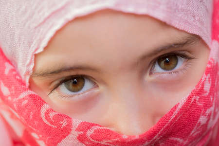 young girl with a veil covering her, close up, studio pictureの写真素材