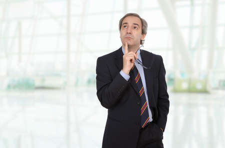 pensive mature business man, at the officeの写真素材