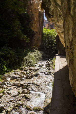 Hiking the Los Cahorros trail through a gorge with a stream near Granada, Spainの写真素材