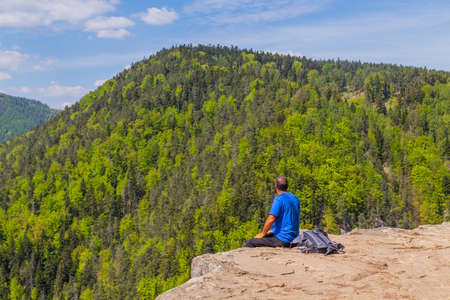 Man on the precipice in Slovak Paradise National Park. Tomasovsky, Slovakiaの写真素材
