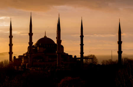 Blue mosque in Istanbul, Turkey. During amazing sunset with clouds and Bosporus at the background.の写真素材
