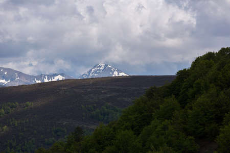 Mountain landscape in the Picos de Europa national park, Spain, Asturias. Snow on the mountain peaks.の写真素材