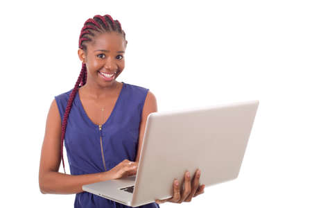 happy beautiful african businesswoman working with a laptop, isolated on white backgroundの写真素材