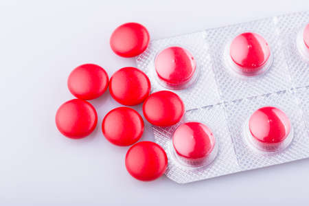 Tablets pills capsule heap mix therapy drugs, over a white backgroundの写真素材