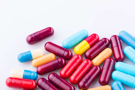 Tablets pills capsule heap mix therapy drugs, over a white backgroundの写真素材