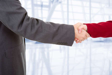 business couple shaking hands at the officeの写真素材
