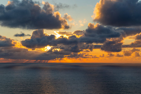 Breathtaking view of the sea with dramatic sunset, seen from a lovely and rustic viewpoint in Cabo Mondego, in Portugal.の写真素材