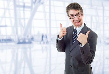 young business man going thumbs up, at the officeの写真素材