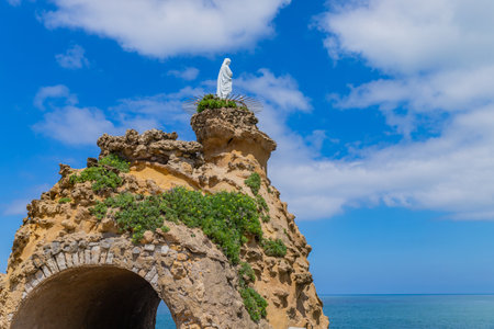The rocher de la vierge (virgin mary rock) in Biarritz. Aquitaine, Basque Country, France.の写真素材