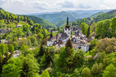 Church in The Spania Dolina village with surrounding landscape, Slovakia, Europe.の写真素材
