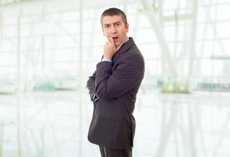 young business man surprised at the officeの写真素材
