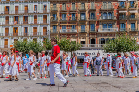 Pamplona, Spain: People celebrate San Fermin festival in traditional white abd red clothing with red necktie, Pamplona, Navarra, Spain.のeditorial素材