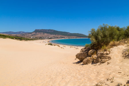 Tarifa, Spain - Tourists walking to The Playa de Bolonia Beach, a unspoiled white sand beach of Tarifa, Cadiz. Andalusia, Spain.の写真素材