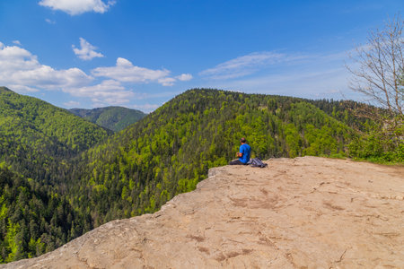 Man on the precipice in Slovak Paradise National Park. Tomasovsky, Slovakiaの写真素材