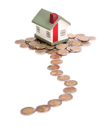 small house and coins, concept, isolated on white backgroundの写真素材
