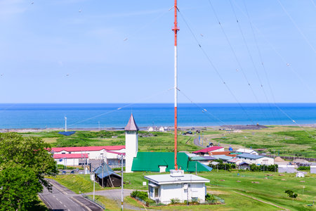 A summer panoramic view from the Fujimigaoka Park Observatory in Enbetsu Town, Teshio District, Hokkaido. Under the clear blue sky, the quiet townscape spreads out before you.の写真素材