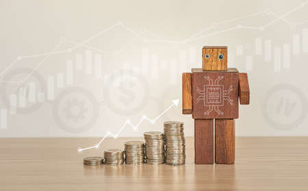 Saving and Investment concept by using Artificial intelligence procession. Stacking of coins with the wooden robot and business graphs background.の写真素材