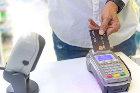 A customer  at the supermarket  is paying  by using a credit card, shopping and retail store concept.の写真素材