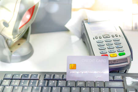A credit card with NFS credit card receiver equipment on the cashier counter. Payment by credit card concept.の写真素材