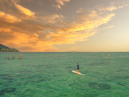 A man was doing paddleboard upon the sunset time in Koh Lipe, Thailand.の写真素材