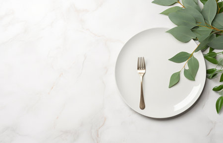 Stylish setting with cutlery and eucalyptus leaves on white marble tableの素材