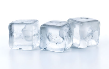 Three melting ice cubes on white backgroundの素材