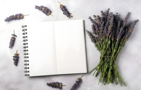 lavender herbs and empty notebook on grey snowy background top viewの素材