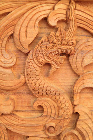 Wood Dragon wall in the templeの写真素材