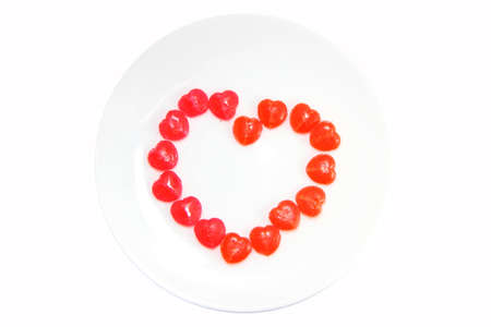 Candy heart sign on white background.の写真素材