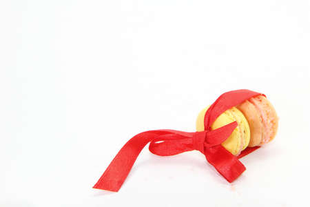macaron with red ribbon on white backgroundの写真素材