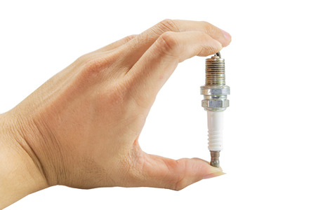 Used spark plug of the car in the hand