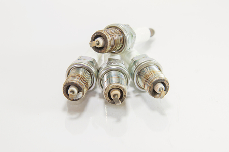 Used spark plug of the car on white background