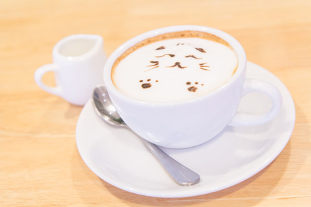 hot cat latte coffee on the tableの写真素材