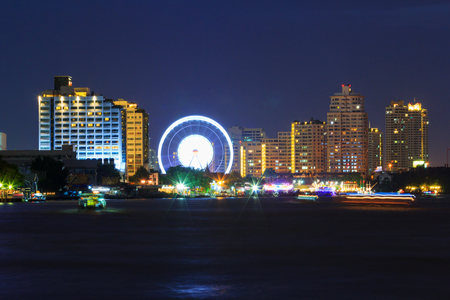 Blur light of Ferris wheel at the amusement park in city /  amusement park near the riverの写真素材