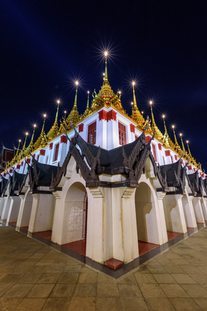 Golden pagoda in Wat Ratcha Nadda Temple in night timeのeditorial素材