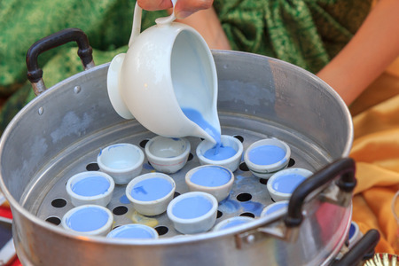 Pour the Dough to cup for make Thai dessert / Pour the Dough for Steamerの写真素材