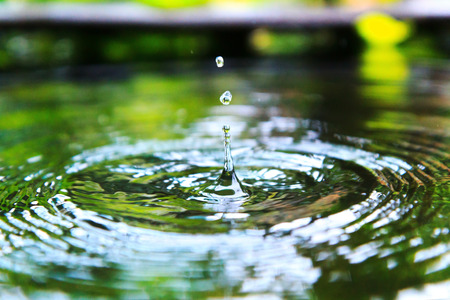 water drops and splash on the pool surfaceの写真素材