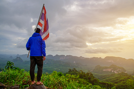 Unidentified Tourism raise the Thailand flag on the mountainの写真素材