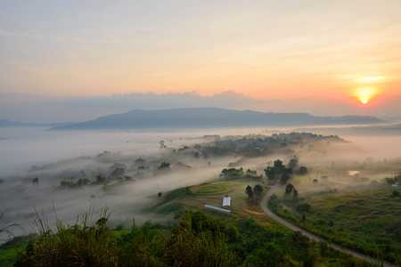 sunrise with mist at the mountainの写真素材