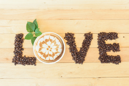 hot cappuccino with nice milk pattern and coffee bean LOVE text / coffee with loveの写真素材